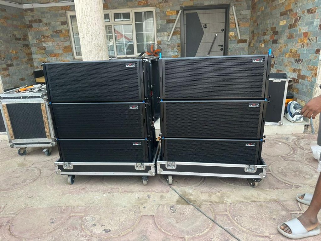 Stacked Admark line array speakers on flight-case dollies